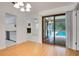 Dining area with sliding glass doors providing pool views and natural light at 18546 Kelly Rd, Spring Hill, FL 34610