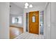 Light and bright entry with tiled floor and a decorative wood door at 18546 Kelly Rd, Spring Hill, FL 34610