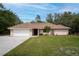 Well maintained single story home with a charming front yard and attached two car garage at 18546 Kelly Rd, Spring Hill, FL 34610