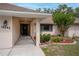 Covered front porch with manicured landscaping accents and elegant entry door at 18546 Kelly Rd, Spring Hill, FL 34610