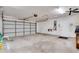 Spacious two car garage with white door, concrete floor, and work bench at 18546 Kelly Rd, Spring Hill, FL 34610