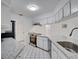 Bright kitchen featuring white cabinets, stainless steel appliances, and granite countertops at 18546 Kelly Rd, Spring Hill, FL 34610