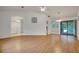 Bright living room with wood floors and sliding glass doors leading to the pool at 18546 Kelly Rd, Spring Hill, FL 34610