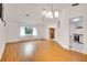 Large living room featuring wood floors, lots of light, and a view into the kitchen at 18546 Kelly Rd, Spring Hill, FL 34610