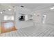 Open-concept living room showcasing tile floors, white walls and a modern kitchen bar for additional seating at 18546 Kelly Rd, Spring Hill, FL 34610