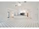 Open concept living space with sleek white tile flooring connecting the kitchen to the Gathering room at 18546 Kelly Rd, Spring Hill, FL 34610