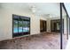Covered brick patio with ceiling fans and sliding glass doors leading to the pool and living areas at 18546 Kelly Rd, Spring Hill, FL 34610