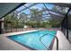 The clear, screened-in pool offers a private and refreshing escape surrounded by greenery at 18546 Kelly Rd, Spring Hill, FL 34610