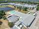 Community aerial view featuring a pool, clubhouse, and serene pond at 1900 58Th N Ave # 26, St Petersburg, FL 33714