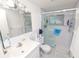 Clean bathroom featuring a glass-enclosed shower, sleek vanity, and tiled walls at 1900 58Th N Ave # 26, St Petersburg, FL 33714