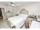 Spacious bedroom features elegant furnishings, a ceiling fan, and ample natural light at 1900 58Th N Ave # 26, St Petersburg, FL 33714