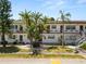 A two-story condo building with a well-manicured lawn and tropical landscaping at 1900 58Th N Ave # 26, St Petersburg, FL 33714