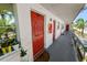 Exterior hallway featuring the entrance with a red door and gray tile at 1900 58Th N Ave # 26, St Petersburg, FL 33714