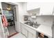 Functional kitchen with stainless steel sink and bright white cabinets at 1900 58Th N Ave # 26, St Petersburg, FL 33714