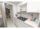 Practical kitchen featuring countertop stove with modern appliances and bright cabinets at 1900 58Th N Ave # 26, St Petersburg, FL 33714