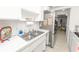 Efficient kitchen with a stainless-steel refrigerator and ample countertop space at 1900 58Th N Ave # 26, St Petersburg, FL 33714