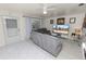 Cozy living room with a comfortable gray couch, ceiling fan, and natural light at 1900 58Th N Ave # 26, St Petersburg, FL 33714
