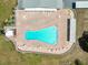 An overhead view of a kidney-shaped swimming pool surrounded by pavers and lounge chairs at 1900 58Th N Ave # 26, St Petersburg, FL 33714