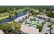 Aerial view of waterfront condos complex with tennis court, lake, and mature trees at 1981 Lakewood Club S Dr # 4M, St Petersburg, FL 33712