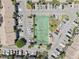 Overhead view of community tennis court surrounded by ample parking and landscaping at 1981 Lakewood Club S Dr # 4M, St Petersburg, FL 33712