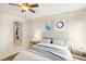Serene bedroom featuring ceiling fan, area rug, neutral walls, ample natural light, and convenient closet space at 1981 Lakewood Club S Dr # 4M, St Petersburg, FL 33712