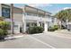 Exterior of a condominium building with a covered balcony and well-maintained landscaping at 1981 Lakewood Club S Dr # 4M, St Petersburg, FL 33712