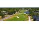 Aerial view of a lush golf course with mature trees and a tranquil blue lake at 1981 Lakewood Club S Dr # 4M, St Petersburg, FL 33712