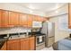 Bright kitchen features wood cabinets, stainless steel appliances, and granite countertops at 1981 Lakewood Club S Dr # 4M, St Petersburg, FL 33712