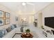 Bright living room with tiled floors, dining area, modern furniture, neutral paint, and ample natural light at 1981 Lakewood Club S Dr # 4M, St Petersburg, FL 33712