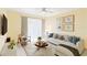 Comfortable living room with neutral walls, tiled floor, and a sliding glass door that fills the space with natural light at 1981 Lakewood Club S Dr # 4M, St Petersburg, FL 33712
