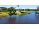 Scenic view of a pond with green grass on the edge and a golf course in the background at 1981 Lakewood Club S Dr # 4M, St Petersburg, FL 33712