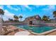 Community pool with seating, lush landscaping, and clear blue water at 1981 Lakewood Club S Dr # 4M, St Petersburg, FL 33712