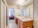 Dual sink bathroom with tile floor and view to the bedrooms at 1984 Hawks View Dr, Ruskin, FL 33570