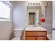 Well-lit bathroom featuring a toilet, vanity, and shower at 1984 Hawks View Dr, Ruskin, FL 33570