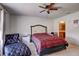 Bedroom with a padded chaise, ceiling fan, and connecting bathroom at 1984 Hawks View Dr, Ruskin, FL 33570
