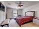 Bedroom with a tufted headboard, ceiling fan, and bright window at 1984 Hawks View Dr, Ruskin, FL 33570