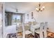 Dining area with modern table and chairs, chandelier lighting, and sliding glass doors at 1984 Hawks View Dr, Ruskin, FL 33570