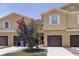 Charming townhome with a well-maintained lawn and a beautiful flowering tree in front of the property at 1984 Hawks View Dr, Ruskin, FL 33570