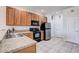 Kitchen features wooden cabinets, stainless steel appliances, tile floor and a double sink at 1984 Hawks View Dr, Ruskin, FL 33570
