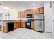 Kitchen features wooden cabinets, stainless steel appliances, and tile floor at 1984 Hawks View Dr, Ruskin, FL 33570