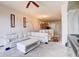 Open-concept living room featuring modern decor, white leather couch, and a view of the kitchen at 1984 Hawks View Dr, Ruskin, FL 33570