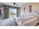 Bright living room with neutral carpet, a white leather couch, and sliding doors to the outside at 1984 Hawks View Dr, Ruskin, FL 33570