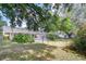 Large backyard with a screened-in pool area and lush greenery, perfect for outdoor enjoyment at 2117 Laindale Pl, Valrico, FL 33596