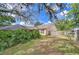 Picturesque backyard featuring lush greenery, mature trees, and a screened-in patio at 2117 Laindale Pl, Valrico, FL 33596