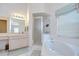 Bathroom features shower, soaking tub and double vanity with pastel wallpaper at 2117 Laindale Pl, Valrico, FL 33596