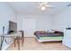 Simple bedroom featuring a ceiling fan, closet, hardwood floors, and a queen bed with a green mattress at 2117 Laindale Pl, Valrico, FL 33596