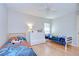 Bright bedroom with two twin beds, ceiling fan, and hardwood floors at 2117 Laindale Pl, Valrico, FL 33596