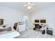 Spacious bedroom with a large window, a light gray carpet, a printer, and two desks with computer monitors at 2117 Laindale Pl, Valrico, FL 33596