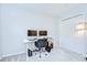 Bright bedroom featuring a gray carpet, a modern white desk with two monitors, and a large closet with sliding doors at 2117 Laindale Pl, Valrico, FL 33596