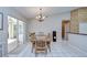 Dining room with tile flooring and wooden table with a chandelier above it at 2117 Laindale Pl, Valrico, FL 33596